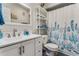 Bathroom with white vanity, a large mirror, and a shower/tub with a patterned shower curtain at 1445 Monroe Ne Dr # F12, Atlanta, GA 30324