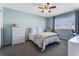 Bedroom with light blue walls, a double bed, a large window, and a white dresser at 1445 Monroe Ne Dr # F12, Atlanta, GA 30324