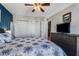 Bedroom featuring a ceiling fan, large closet doors, and dark gray dresser with a TV on top at 1445 Monroe Ne Dr # F12, Atlanta, GA 30324