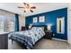 Bedroom with blue accent wall, ceiling fan, and a queen bed with a blue and white patterned comforter at 1445 Monroe Ne Dr # F12, Atlanta, GA 30324