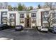 Apartment building featuring assigned parking spaces and manicured landscaping at 1445 Monroe Ne Dr # F12, Atlanta, GA 30324