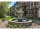 Ornate water fountain with sculptural details sits in front of condo building with screened in patios at 1445 Monroe Ne Dr # F12, Atlanta, GA 30324