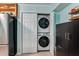 Convenient laundry closet with stacked washer and dryer, and storage cabinets at 1445 Monroe Ne Dr # F12, Atlanta, GA 30324