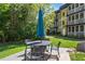 Outdoor patio with dining table and chairs, perfect for enjoying meals outside in a lush environment at 1445 Monroe Ne Dr # F12, Atlanta, GA 30324