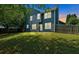 A two-story home overlooks the expansive backyard with a privacy fence at 254 Wood Duck Dr, Jonesboro, GA 30238