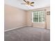 Spacious bedroom featuring a ceiling fan and window bringing in natural light at 254 Wood Duck Dr, Jonesboro, GA 30238