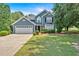 Charming blue two-story home with well-manicured lawn and attached two-car garage in a desirable neighborhood at 254 Wood Duck Dr, Jonesboro, GA 30238