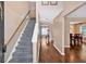 Inviting foyer featuring wood floors, staircase with carpet runner and views to the adjacent dining room at 254 Wood Duck Dr, Jonesboro, GA 30238