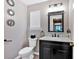 Stylish powder room features a black vanity with marble countertop, decorative mirror, and modern fixtures at 254 Wood Duck Dr, Jonesboro, GA 30238