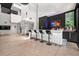 Entertaining bar area with sleek countertops, bar stool seating, and neon lighting in an open-concept living space at 3891 Wieuca Rd, Atlanta, GA 30342