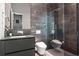 Modern bathroom featuring sleek tile walls, a glass-enclosed shower, contemporary fixtures, and a floating vanity at 3891 Wieuca Rd, Atlanta, GA 30342