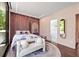 Stylish bedroom featuring unique wall texture, modern lighting, a round rug, and ensuite bathroom entrance at 3891 Wieuca Rd, Atlanta, GA 30342