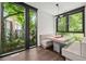 Inviting breakfast nook with built-in seating, hardwood floors, and expansive windows overlooking a private outdoor area at 3891 Wieuca Rd, Atlanta, GA 30342