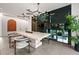 Dining area with modern light fixture, table, and glass window overlooking backyard at 3891 Wieuca Rd, Atlanta, GA 30342