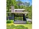 Stunning modern home surrounded by lush greenery with sleek lines and expansive windows at 3891 Wieuca Rd, Atlanta, GA 30342