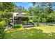Modern architectural home with expansive lawn, sleek black trim, and thoughtful landscaping at 3891 Wieuca Rd, Atlanta, GA 30342
