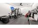 Spacious home gym with state-of-the-art equipment, rubber flooring, and a wall-mounted television at 3891 Wieuca Rd, Atlanta, GA 30342