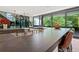 Spacious kitchen featuring a modern island with seating, a cooktop, and large windows offering ample natural light at 3891 Wieuca Rd, Atlanta, GA 30342