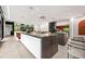 Open kitchen with barstool seating, modern appliances, sleek cabinetry, and seamless access to living spaces at 3891 Wieuca Rd, Atlanta, GA 30342