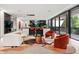 Open-concept living space with modern kitchen, stylish seating, and expansive glass doors at 3891 Wieuca Rd, Atlanta, GA 30342