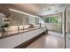 Modern main bathroom with dual sinks, vanity, large mirror, and glass-enclosed shower at 3891 Wieuca Rd, Atlanta, GA 30342