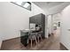 Bright home office featuring hardwood flooring, a modern desk with storage, and a partial view of an adjoining room at 3891 Wieuca Rd, Atlanta, GA 30342