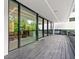 Contemporary patio boasts floor-to-ceiling windows, an elegant overhang, and dark-stained wood floors, perfect for entertaining at 3891 Wieuca Rd, Atlanta, GA 30342