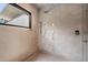 A modern shower featuring multiple shower heads and body sprayers with textured walls at 3891 Wieuca Rd, Atlanta, GA 30342