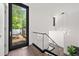 Bright modern staircase features glass railings, wood floors, contemporary light fixture, and ample natural light at 3891 Wieuca Rd, Atlanta, GA 30342