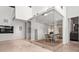 A glass-enclosed wine room features wine storage and a round table with chairs for wine tastings at 3891 Wieuca Rd, Atlanta, GA 30342