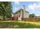 A large backyard with a deck, a wooden fence, and well-maintained green grass at 5745 Crystal Springs Way, Powder Springs, GA 30127