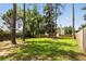 Grassy backyard featuring mature trees, a wooden fence, and a tree swing at 5745 Crystal Springs Way, Powder Springs, GA 30127