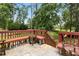 Outdoor deck with chairs and tables, overlooking tree-lined yard at 5745 Crystal Springs Way, Powder Springs, GA 30127
