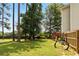 Grassy backyard featuring mature trees, a wooden fence, and a picnic table at 5745 Crystal Springs Way, Powder Springs, GA 30127