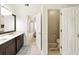 Bathroom featuring double sink vanity, doorway to bedroom, and toilet in separate room at 5745 Crystal Springs Way, Powder Springs, GA 30127