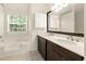 Bright bathroom with double sink vanity, garden tub, and white tile at 5745 Crystal Springs Way, Powder Springs, GA 30127