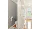 Tight view of a half bathroom with gray walls and adjacent entry door at 5745 Crystal Springs Way, Powder Springs, GA 30127