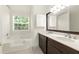 Well-lit bathroom featuring a tub and a vanity with double sinks at 5745 Crystal Springs Way, Powder Springs, GA 30127