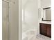 Bathroom with a shower, garden tub, and double sink vanity with dark wood at 5745 Crystal Springs Way, Powder Springs, GA 30127