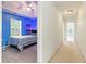 Bedroom next to hallway featuring a bright blue paint color and tray ceilings at 5745 Crystal Springs Way, Powder Springs, GA 30127