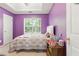 Cozy bedroom with window, lavender walls and white trim at 5745 Crystal Springs Way, Powder Springs, GA 30127