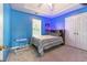 Bright blue bedroom with a tray ceiling, a window, and a study desk at 5745 Crystal Springs Way, Powder Springs, GA 30127