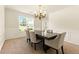 Bright dining room featuring a chandelier, a table with six chairs, and a window with natural light at 5745 Crystal Springs Way, Powder Springs, GA 30127