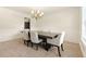 Bright dining room featuring a chandelier, a table with six chairs, and a window with natural light at 5745 Crystal Springs Way, Powder Springs, GA 30127