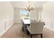 This dining room features a window with a view, chandelier, and a table with six chairs at 5745 Crystal Springs Way, Powder Springs, GA 30127