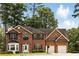 Attractive brick home featuring a well-kept lawn, bay window, black shutters, and an attached two-car garage at 5745 Crystal Springs Way, Powder Springs, GA 30127