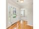 Welcoming foyer with hardwood floors, decorative front door, and views into the living area at 5745 Crystal Springs Way, Powder Springs, GA 30127