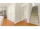 Hallway with hardwood floors, a closet, and access to the upper level of the home at 5745 Crystal Springs Way, Powder Springs, GA 30127