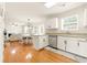 Open-concept kitchen and dining area with hardwood floors, island, and bright lighting at 5745 Crystal Springs Way, Powder Springs, GA 30127