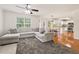Spacious living room with plush seating, a kitchen in the background, and natural light from the windows at 5745 Crystal Springs Way, Powder Springs, GA 30127